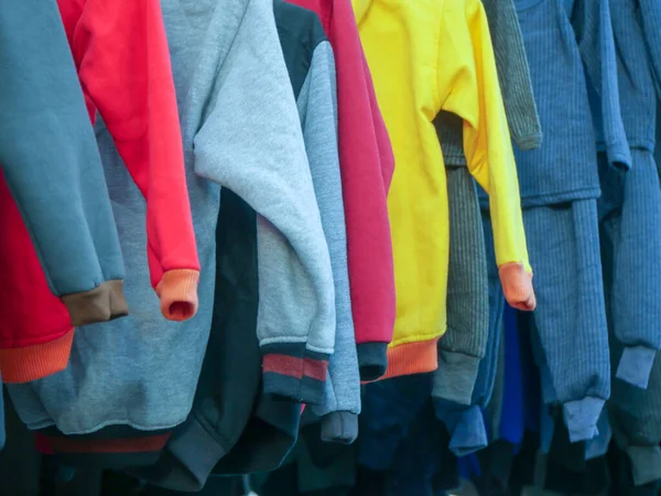 Various dresses hanging at garment shop.