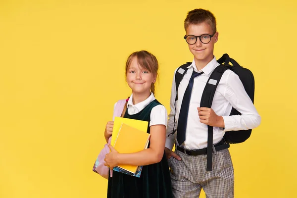 Portrait School Girl Boy Textbooks Backpack Yellow Background Back School — Zdjęcie stockowe