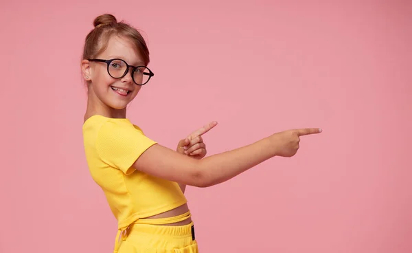 Smart Child Girl Yellow Clothes Eyeglasses Pink Background Shows Thumbs — 스톡 사진