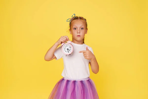 Portrait Cute Girl Small Alarm Clock Yellow Background — Stock Fotó