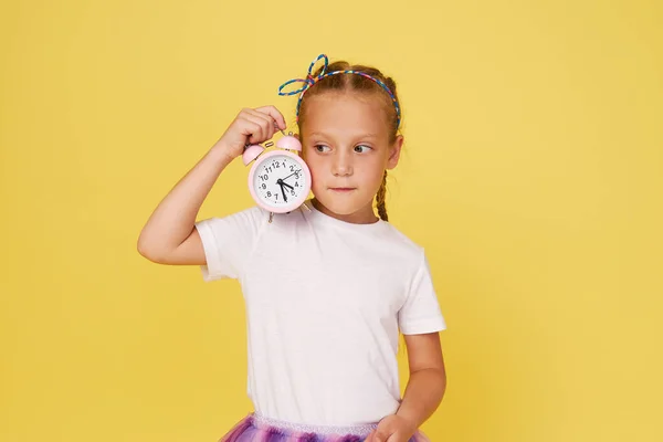 Portrait Cute Girl Small Alarm Clock Yellow Background — Stock Fotó