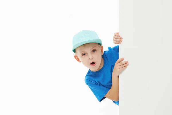 Şık Çocuk Beyaz Bir Duvarın Arkasından Dışarı Bakan Mavi Tişörtlü — Stok fotoğraf