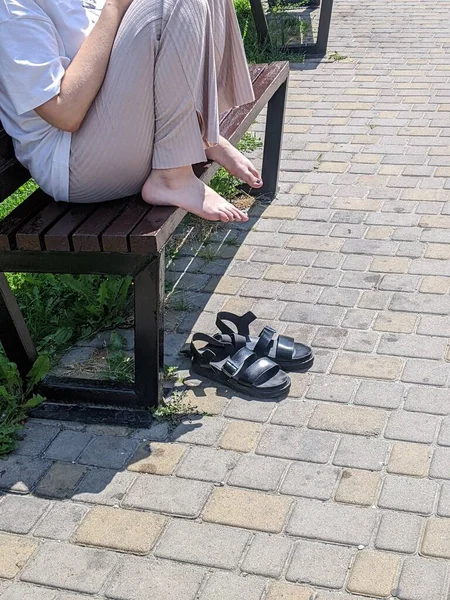 Woman His Feet Bench Sitting Pavement — 스톡 사진