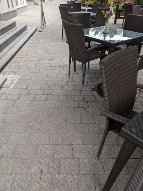 empty white table with chairs and tables on the street in the city of lviv
