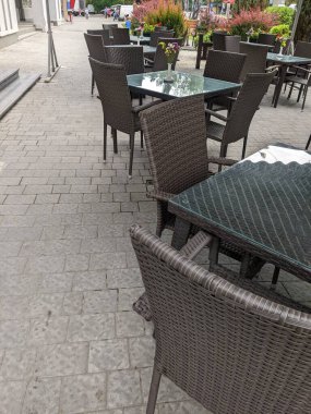 empty white table with chairs and tables on the street in the city of lviv