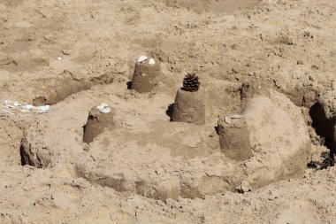 A brilliant sandcastle and ditch built by a child on Formby Beach in Liverpool, United Kingdom. This photo was taken during the heatwave and extremely hot weather.