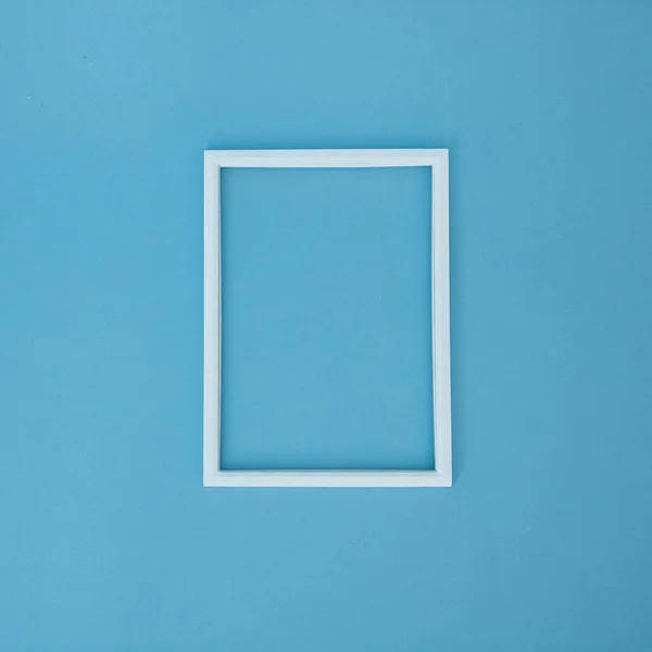 stock image White frame on a blue background. Flat lay concept.