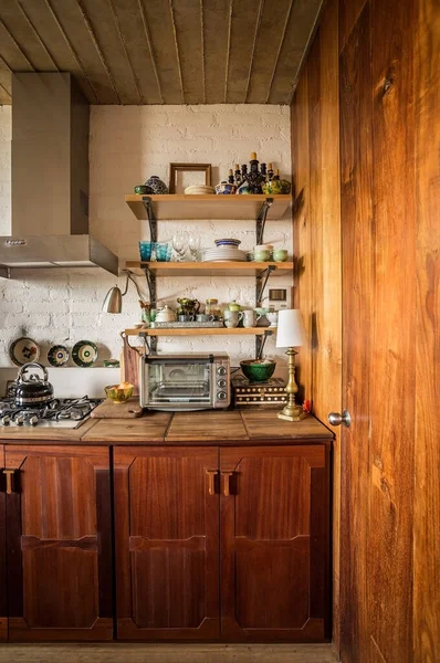 modern kitchen japandi style, shelves in natural wood kitchen, oak, oak, with different ceramic objects, utensils, as well as decorative vases, the kitchen is made of wood as well as the bar.