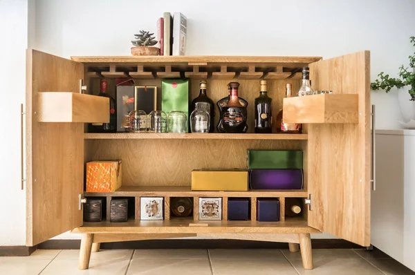 wine cabinet in the interior. alcohol storage in a restaurant or in the house. collection of wine and cognac. storage of alcohol, in a solid wood buffet