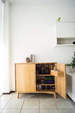 wine cabinet in the interior. alcohol storage in a restaurant or in the house. collection of wine and cognac. storage of alcohol, in a solid wood buffet
