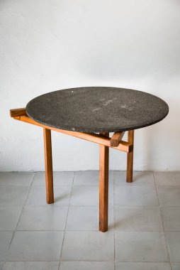 designer side or center coffee table, top in natural stone, volcanic stone, quarry or terrazzo, base in solid wood, purple rose, oak or tzalam. Interior table, decorations and interior design wooden