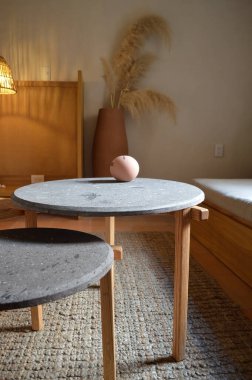 designer side or center coffee table, top in natural stone, volcanic stone, quarry or terrazzo, base in solid wood, purple rose, oak or tzalam. Interior table, decorations and interior design wooden