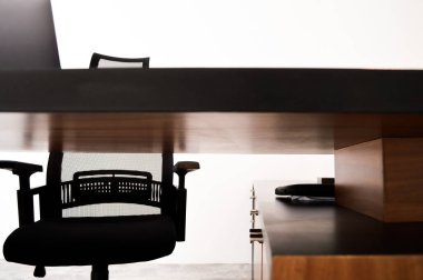 modern designer desk for office, business and creative spaces, with computer and office work elements, for companies, small businesses and enterprises. Wooden desk in black color with storage drawers.