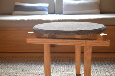 designer side or center coffee table, top in natural stone, volcanic stone, quarry or terrazzo, base in solid wood, purple rose, oak or tzalam. Interior table, decorations and interior design wooden