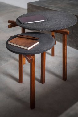 designer side or center coffee table, top in natural stone, volcanic stone, quarry or terrazzo, base in solid wood, purple rose, oak or tzalam. Interior table, decorations and interior design wooden