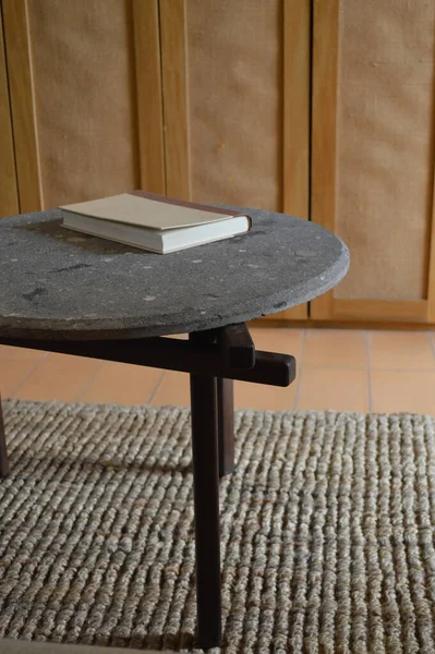 designer side or center coffee table, top in natural stone, volcanic stone, quarry or terrazzo, base in solid wood, purple rose, oak or tzalam. Interior table, decorations and interior design wooden