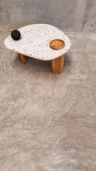 designer side or center coffee table, top in natural stone, volcanic stone, quarry or terrazzo, base in solid wood, purple rose, oak or tzalam. Interior table, decorations and interior design wooden