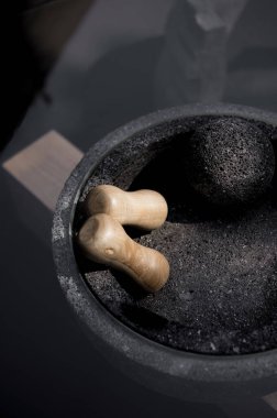 designer side or center coffee table, top in natural stone, volcanic stone, quarry or terrazzo, base in solid wood, purple rose, oak or tzalam. Interior table, decorations and interior design wooden