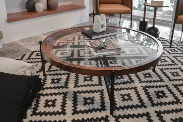 Double table in brown wood, with circular metal edges and several glass shelves. Empty surface. Round table center with fine finishes.