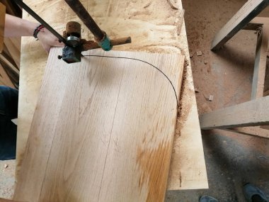 band saw wood cutting, back of an armchair, furniture design, the wood is natural oak, solid wood or hardwood. The cutting is hand made by a carpenter.