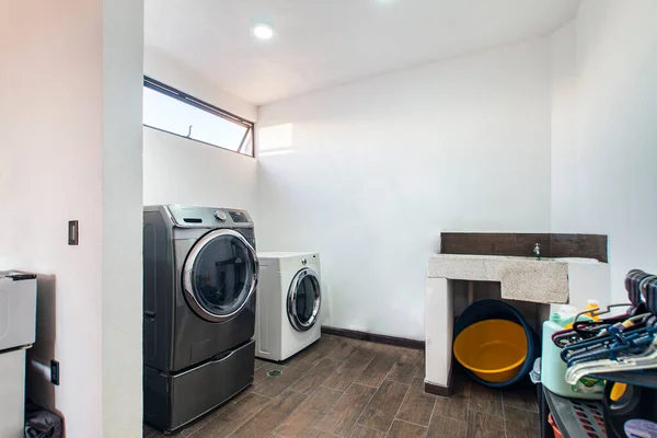 laundry room, with washing machine, dryer, detergent area, hand washing sink, with water supply.