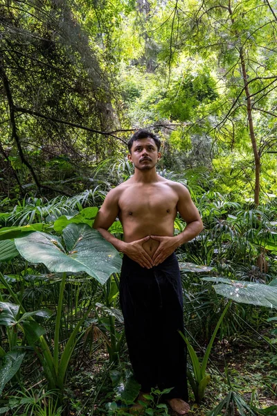 young man doing meditation on a stairway in a forest, mexico, guadalajara