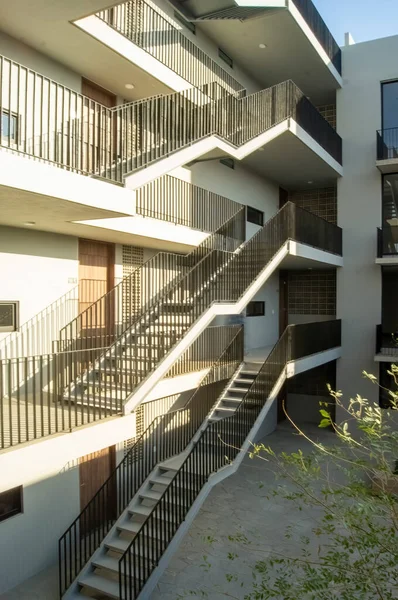 stairs apartment building, white building income wooden doors, central courtyard, mexico, latin america