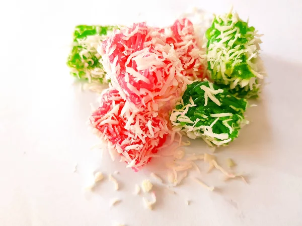 A bunch of Pandan Sticky Rice Cake, filled with brown sugar sprinkled with grated coconut, an Indonesian Traditional Snacks