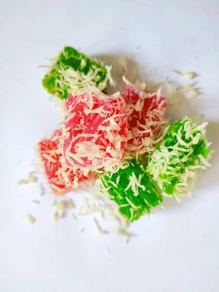 A bunch of Pandan Sticky Rice Cake, filled with brown sugar sprinkled with grated coconut, an Indonesian Traditional Snacks