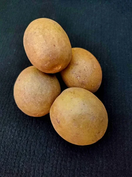 fresh sapote sapodilla fruits isolated on black background