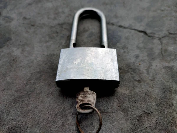 Gray Padlock on the wall.
