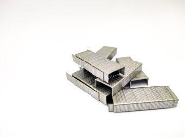 Stacks of metal staples for stapler on white background with copyspace