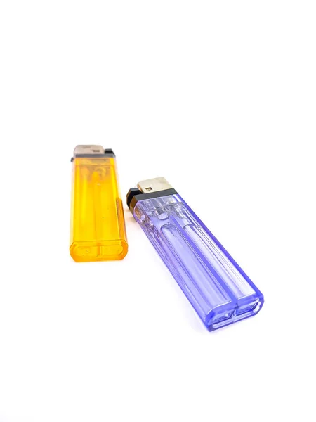 Orange, and blue plastic gas lighter. Gas lighter on white background. Closeup shot, top view.