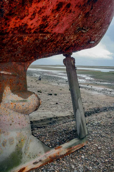 Rudder of a boat without a propeller stranded on a Patagonian be
