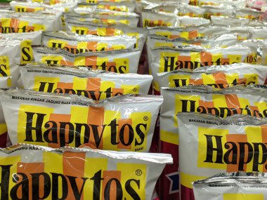 happytos snacks arranged in supermarket.  Medan Indonesia July 2022