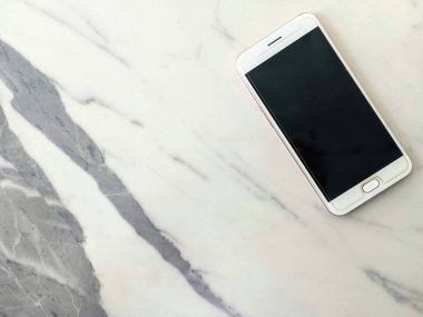 white smartphone on marble background