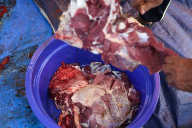 Making the process of tasty fresh beef meat. close up and texture of Traditional Red beef meat. Meat food background. White, blue, red, and black bucket