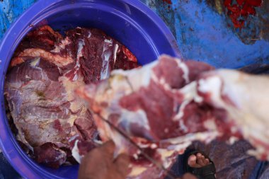 Making the process of tasty fresh beef meat. close up and texture of Traditional Red beef meat. Meat food background. White, blue, red, and black bucket