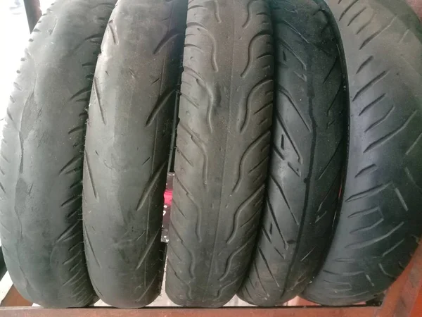 Stack of used tires at the bike service shop.Motorcycle used wheels.Bike worn tires