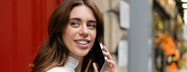 Happy woman talking on mobile phone on urban street in Paris, banner — Stock Photo