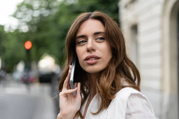 Retrato de mulher morena falando no smartphone na rua em Paris — Fotografia de Stock