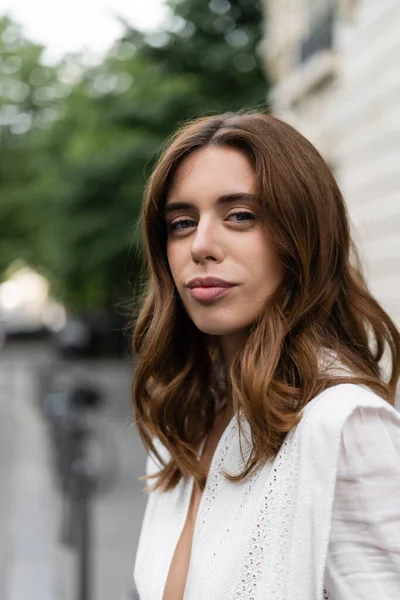 Trendy brunette woman looking at camera on street in France — Stock Photo