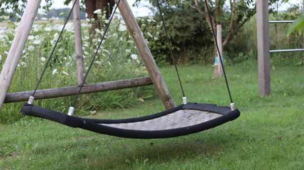 Old swing in the garden. The children have grown, the swings have remained.