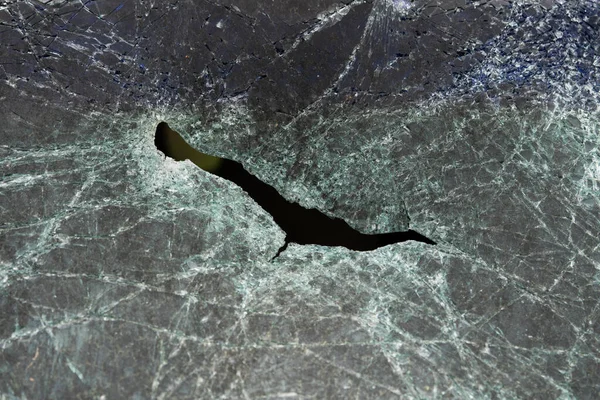 Abstract image of broken glass texture, background. Close-up of a broken car windshield. Broken and damaged car