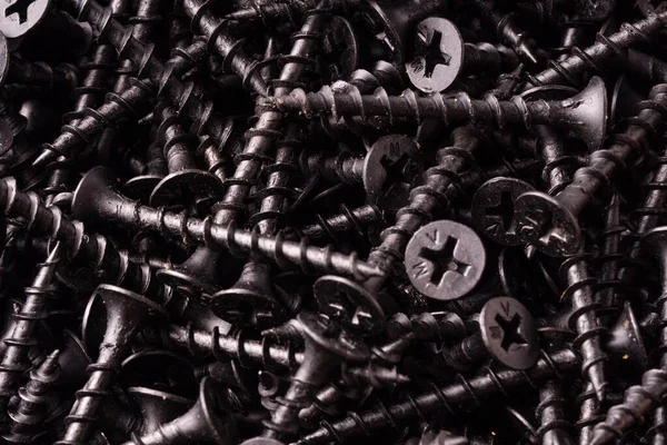 Abstract Background Pile Shiny Black Screws — Stockfoto