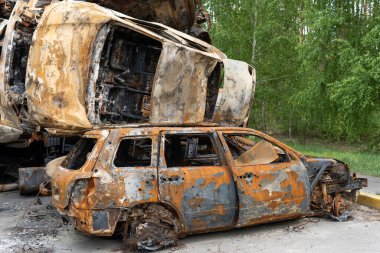 Irpin, Kyiv region, Ukraine - April 28, 2022: Car cemetery in Irpin, the consequences of the Russian army invasion of Ukraine. Destroyed cars of the civilian population.