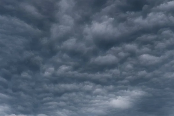 Rain clouds background. The clouds turn dark gray, like big smoke before rain