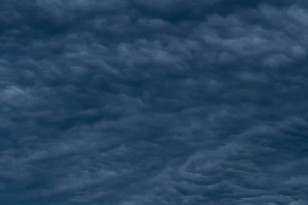 Rain clouds background. The clouds turn dark gray, like big smoke before rain