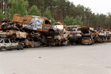 Irpin, Kyiv region, Ukraine - April 28, 2022: Car cemetery in Irpin, the consequences of the Russian army invasion of Ukraine. Destroyed cars of the civilian population.