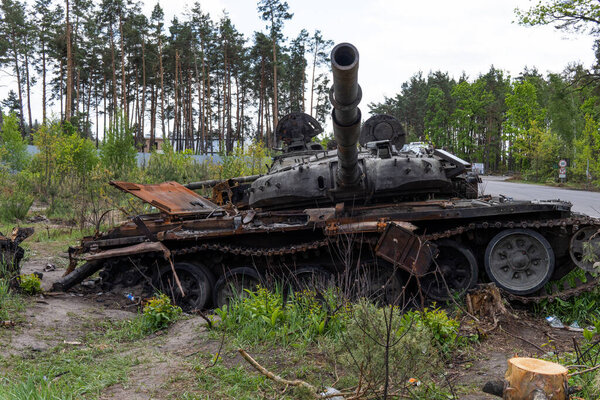 DMITRIVKA, UKRAINE - APRIL 02, 2022: Destroyed tanks and combat vehicles of the Russian occupiers near the village of Dmitrievka, Kyiv region.